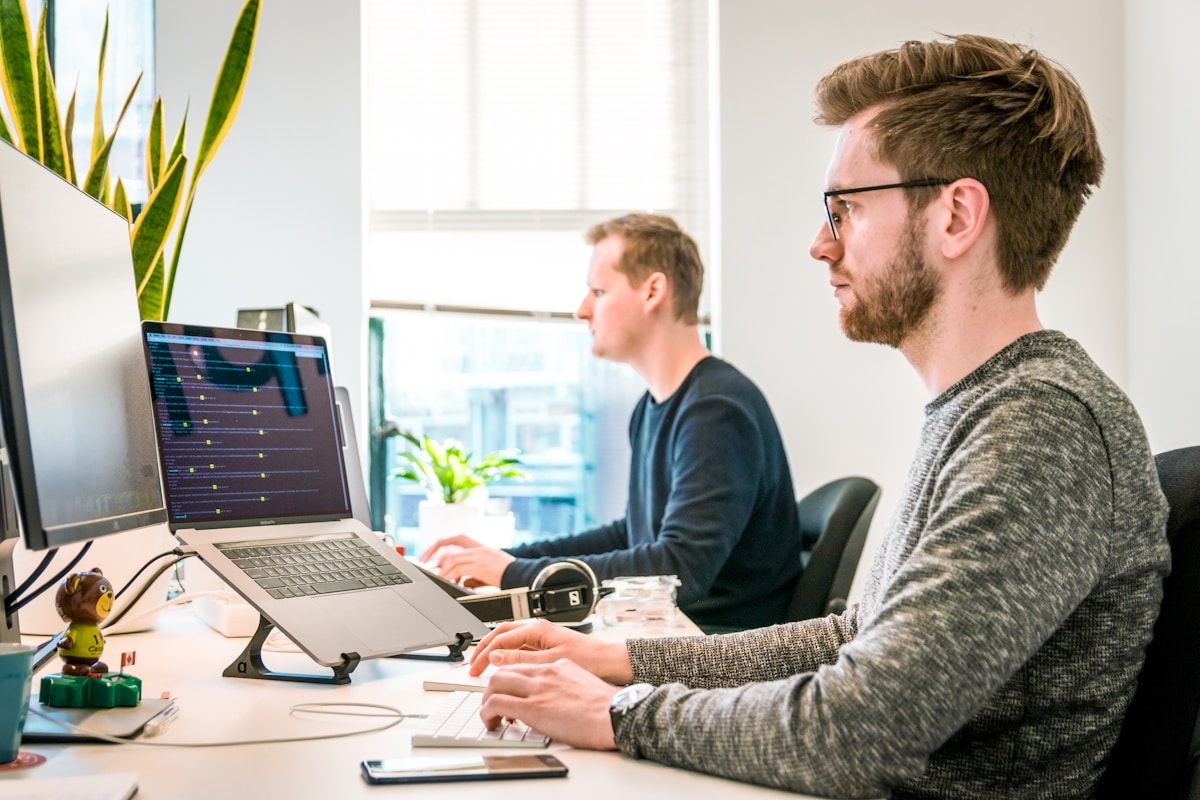 Software engineers collaborating on full-stack enterprise application code